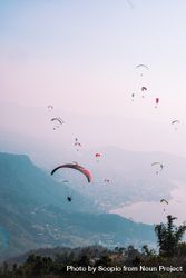 People riding parachute over mountains 48nQJ0