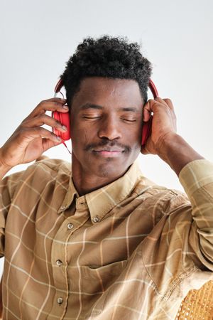 Concentrated Black man enjoying music from headphones