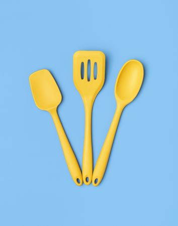 Yellow kitchen utensils on a blue table