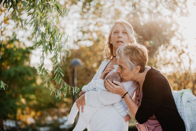 Two mature women with a baby in the park