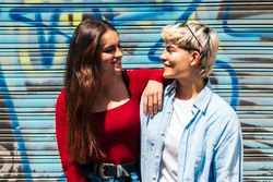 portrait of two young women looking at each other