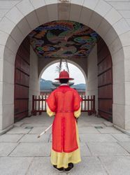 Seoul, South Korea - August, 08 2017: Anonymous man in traditional Korean clothes near archway