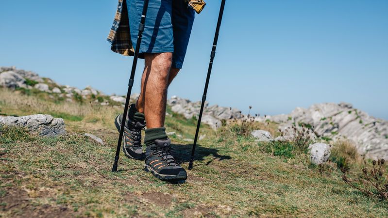 Male with hiking poles on a trek