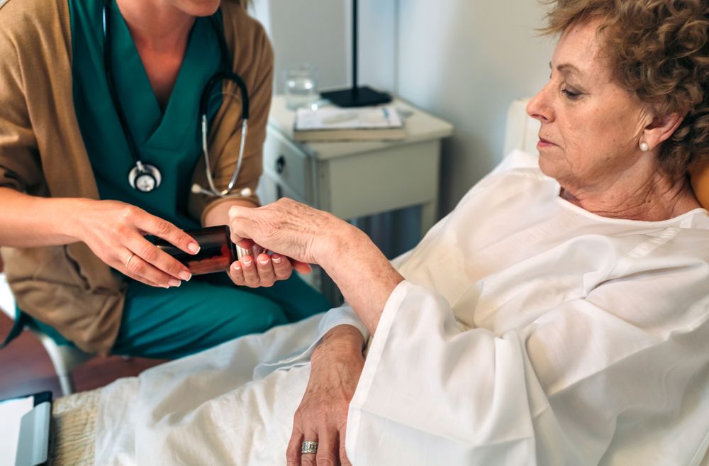 Doctor giving medication dose to mature patient