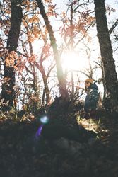 Woman walking in autumn forest