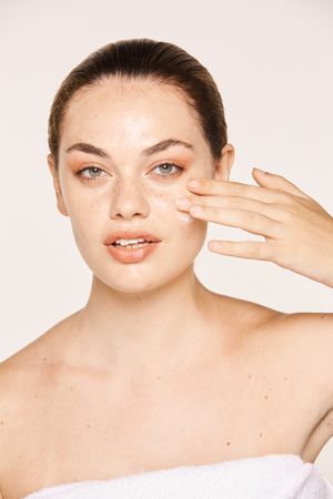 Amiable female taking care of face