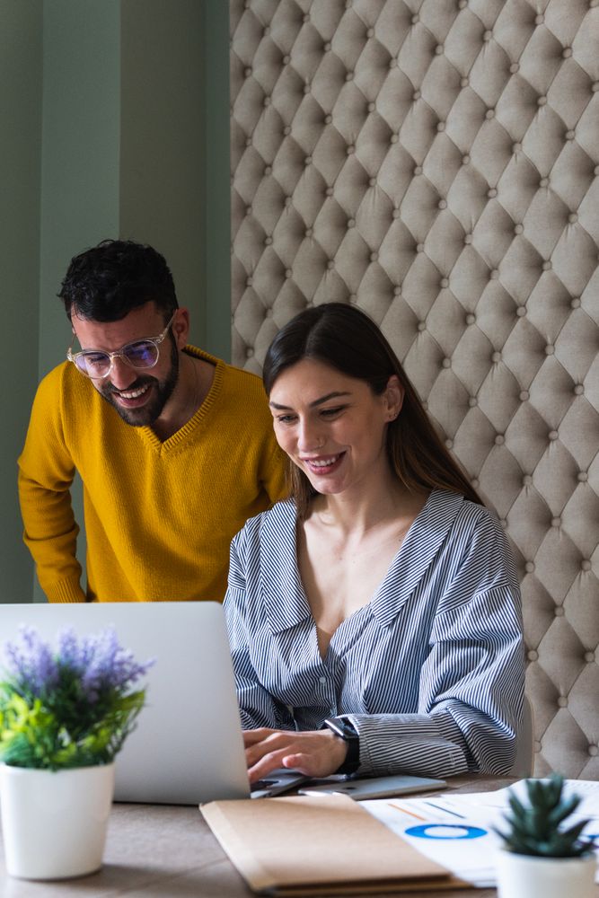 Focused colleagues working on laptops in coworking space