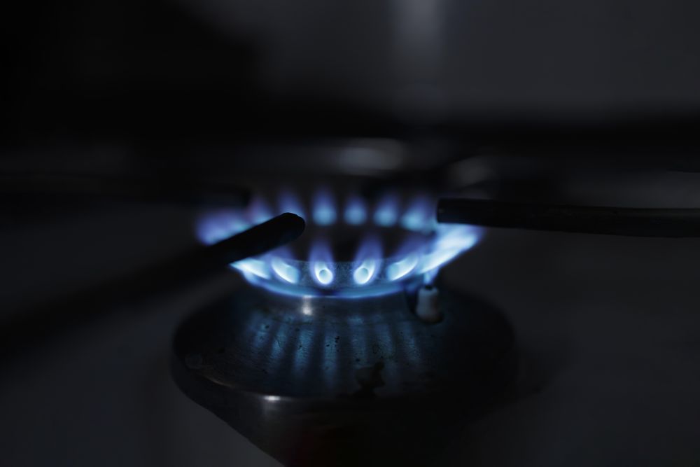 Side view of blue flame on range