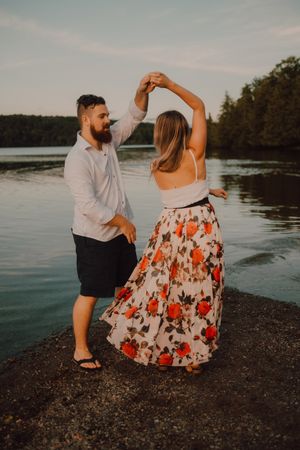 Loving couple standing ankle deep in water on beach