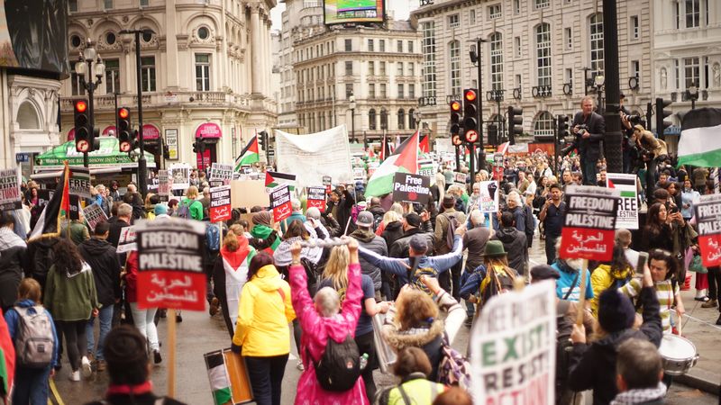 Back view of people at the demonstration for Palestine against Israeli aggression in London, UK