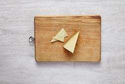 Chunk of Parmesan cheese on cutting board