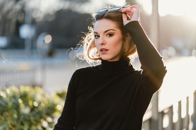 Woman taking off her sunglasses on the street