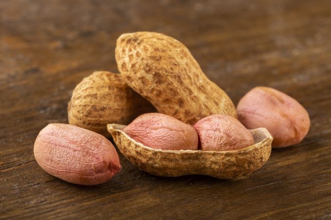 Dry peanut on the wooden background.