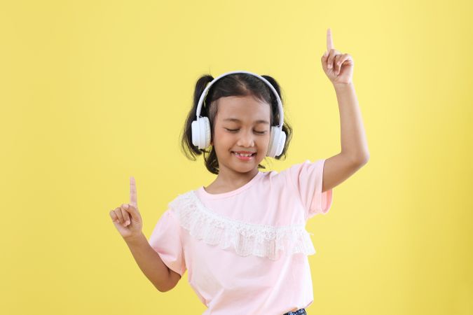 Cute Asian Kids Listening to Music using  Wireless Headset