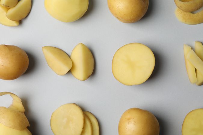 Potatoes cut in different ways arranged in rows, close up