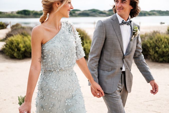 Happy young married couple spending time together at seaside