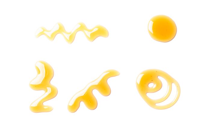 Sweet honey smears isolated on studio background