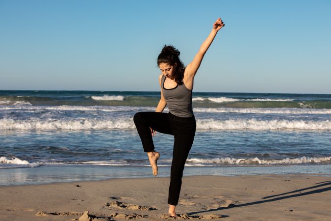 Woman with dancing near water on shore