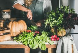Woman cutting long beans in kitchen