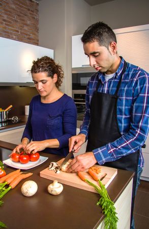 Couple cutting vegetables for dinner