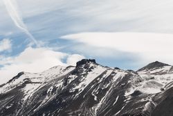 Mountain peak abutting sky in desert valley