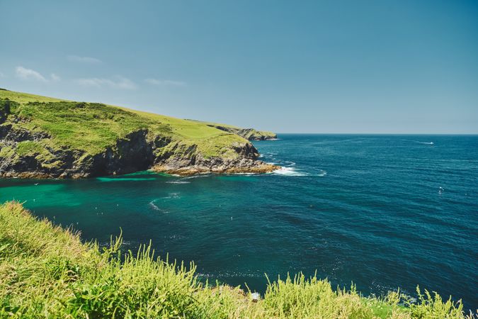 Beautiful sea with green grassy cliffs