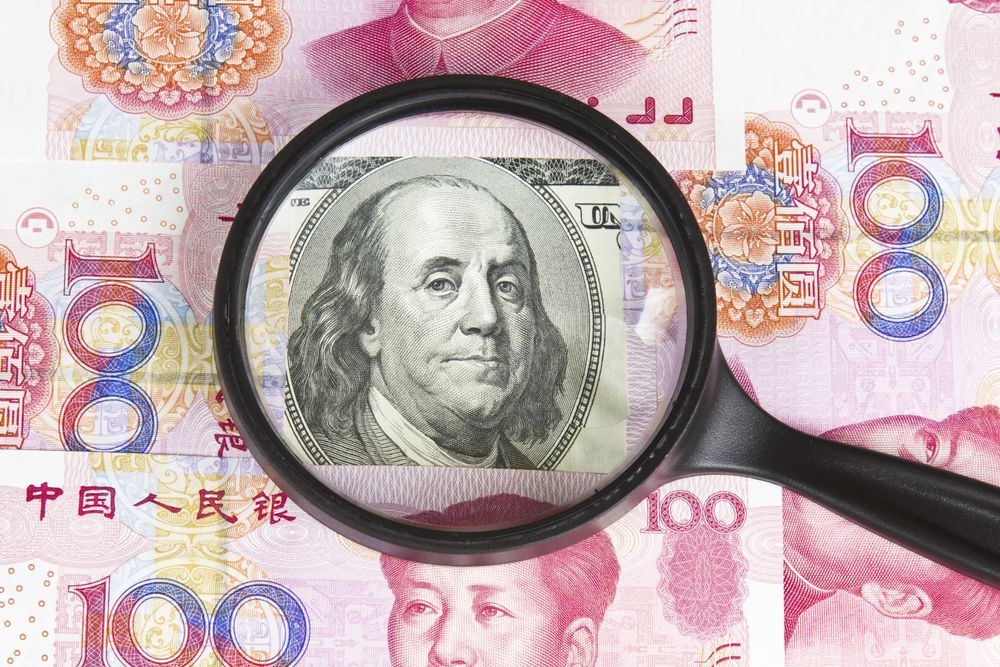 100 US dollar bill surrounded by Chinese Yen