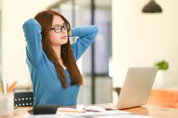 Young business woman resting while using laptop