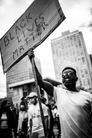 MONTREAL, QUEBEC, CANADA – June 7 2020- Man holding a Black Lives Matter sign