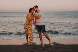 Loving couple embracing happily on sandy beach