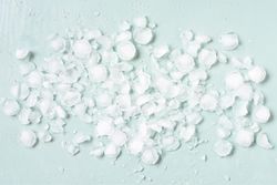 Crushed ice on baby blue background
