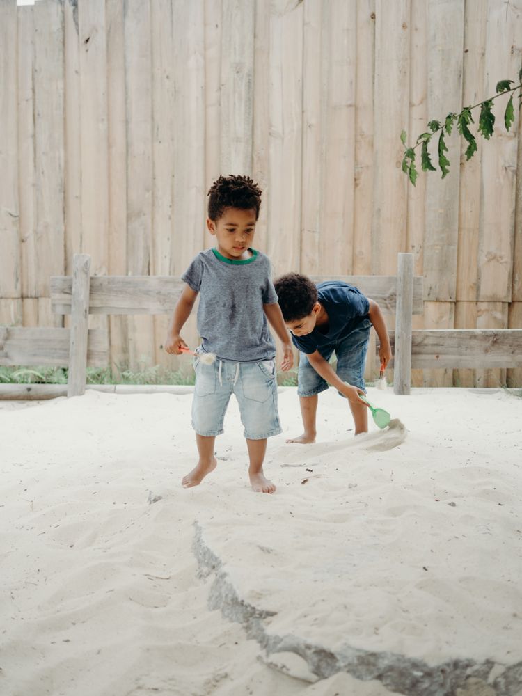 Black children playing with sand