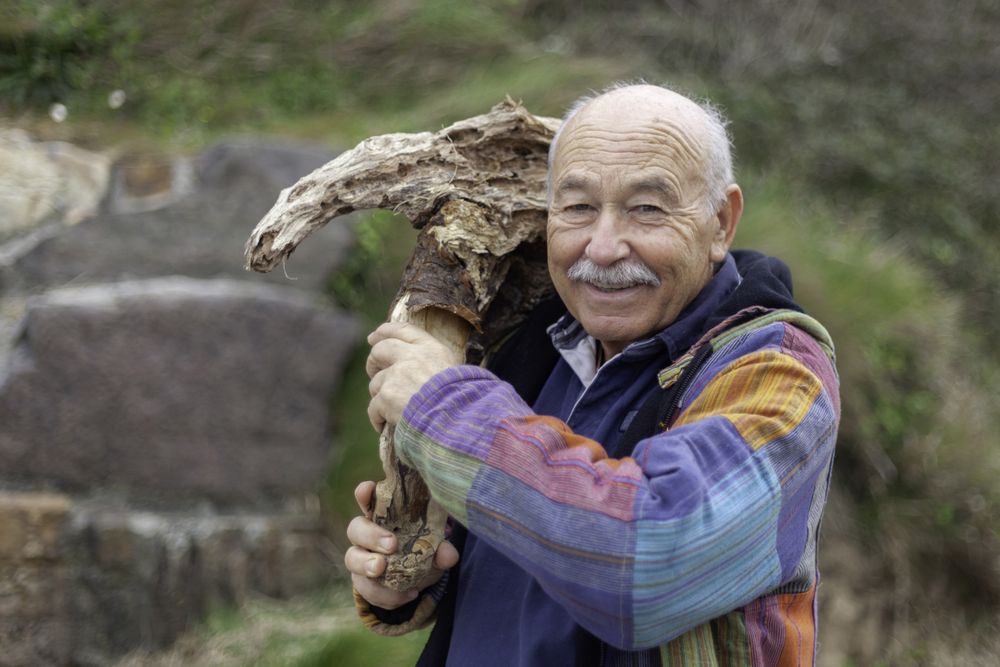 Mature man breaking stone formation