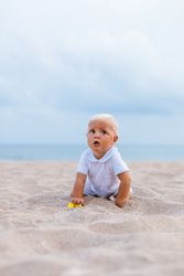 Blond baby on the beach