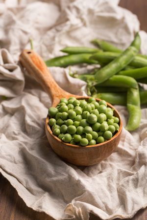Peas in a wooden scoop