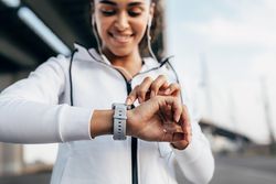 Smiling athlete checking results during fitness training