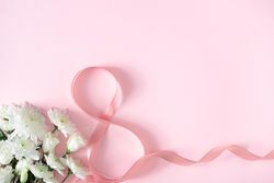 Roses and spring flowers with pink ribbon