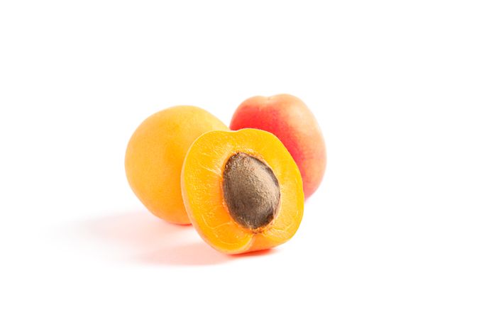 Fresh sweet apricots isolated on blank background