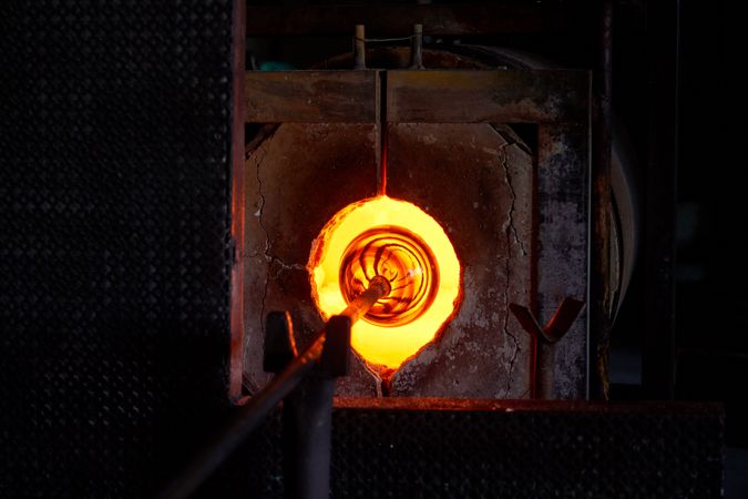 Glass product placed in furnace in blowing shop