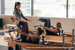 Two fitness women being trained by a pilates instructor 5wyvAb