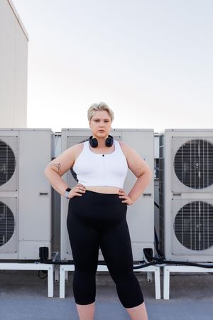 Woman with hands on her hips on a rooftop