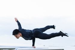 Athlete doing exercise on parallel bars