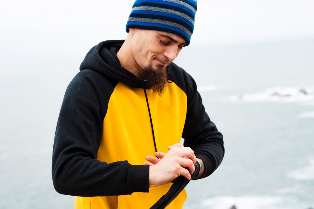 Male kickboxer bandaging hand for training