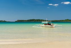 Boat on shallow of sandy sea shore