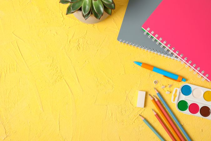 Flat lay composition with school supplies on color background, space for text