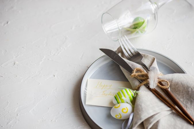 Easter table setting with green decorative eggs and napkin