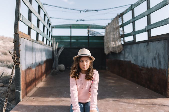Focused girl resting in truck body