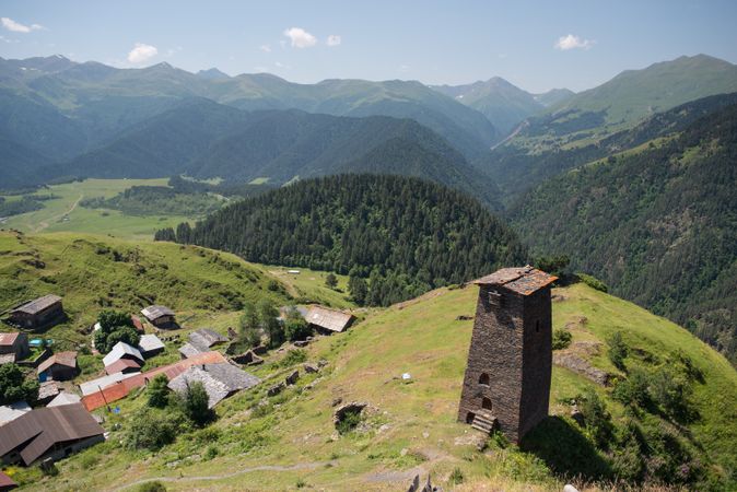 Tall old defensive building in majestic mountains in summer sunny day