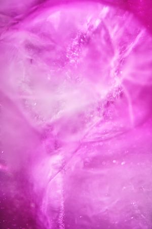 Ice with lilac colored tonic