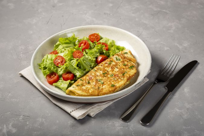 Omelet with cheese and lettuce and tomato salad.